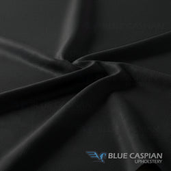 Close-up of black fabric with Blue Caspian Upholstery logo.